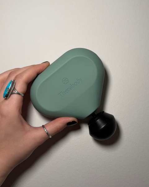 Katie Gunderman holding therabody mini theragun