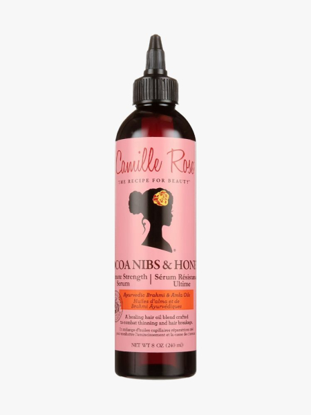 Camille Rose Cocoa Nibs + Honey Ultimate Strength Serum in branded component on a light gray background